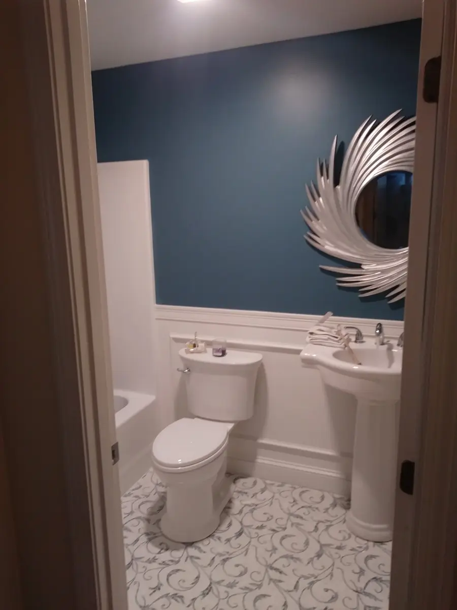 Bathroom with blue wall and pedestal sink